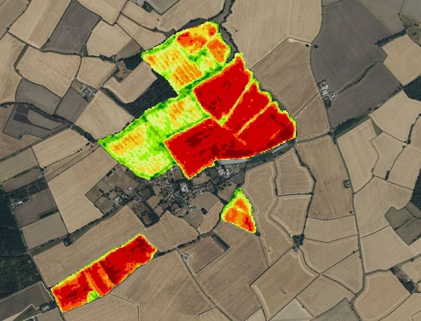 Variable-rate application map laid over satellite imagery of a farm, showing high, medium and low zones across each field
